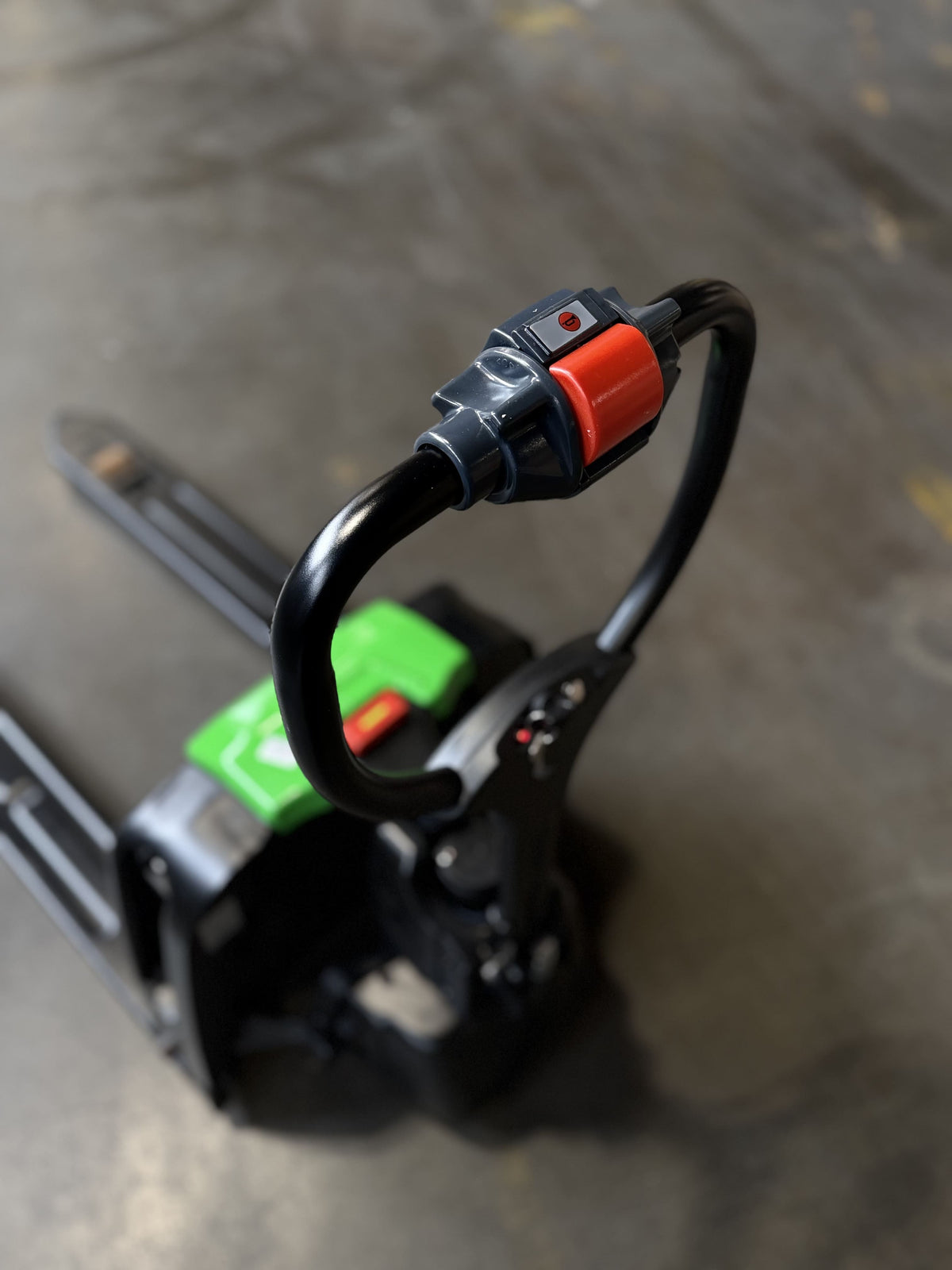 Top angle view of Raelon F4 3300 lb electric pallet jack on warehouse floor